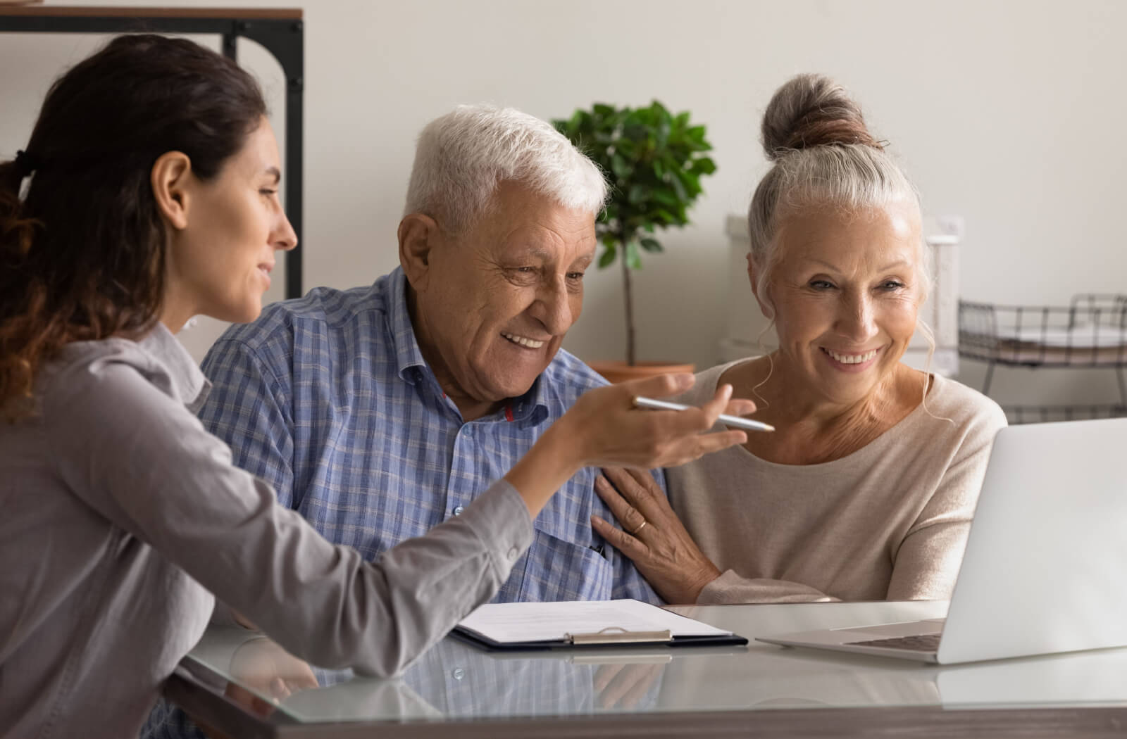 A senior man and a senior a woman talking to an insurance agent