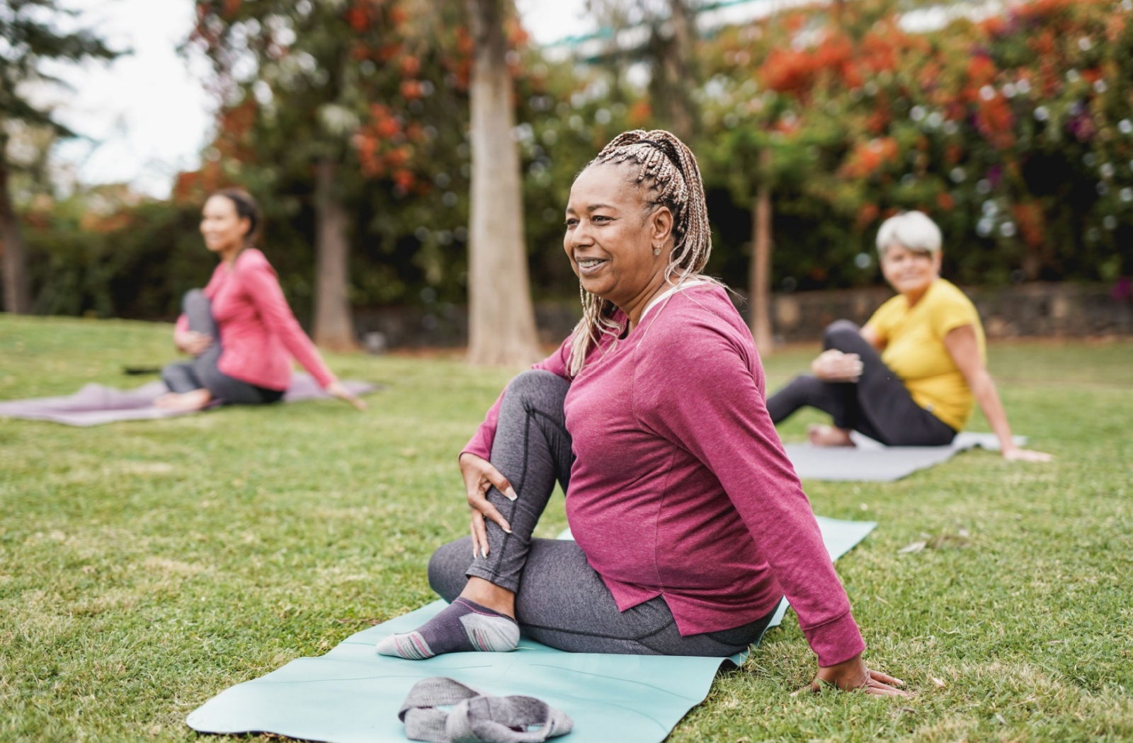 A couple of seniors enjoying an outdoor yoga session.