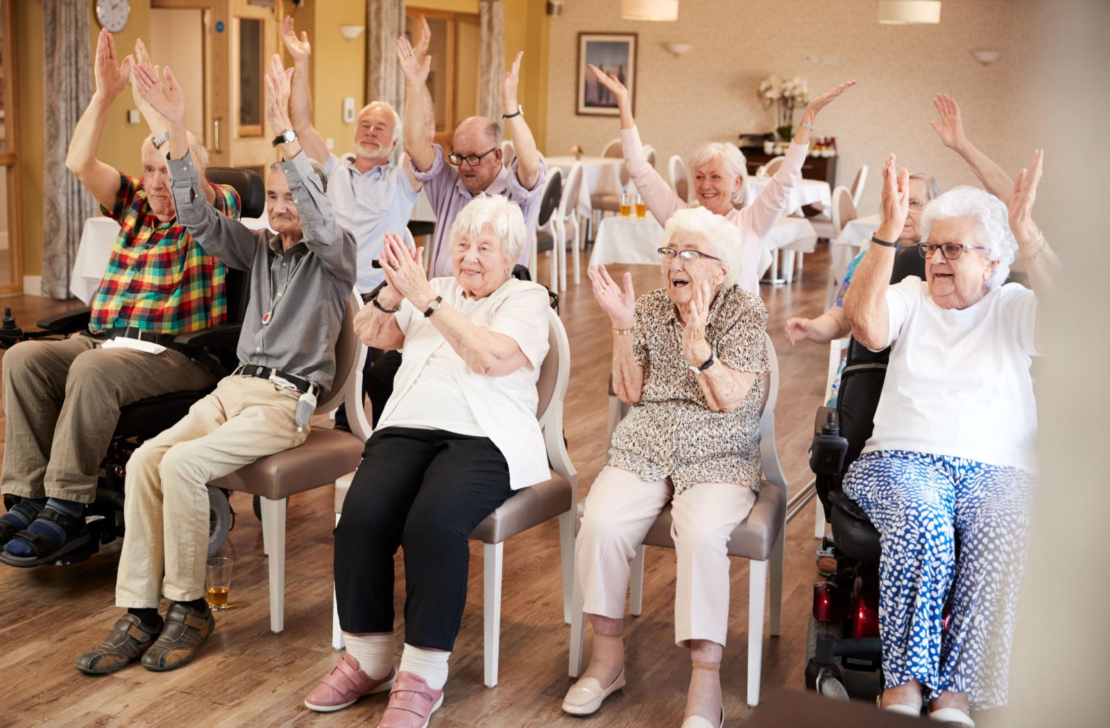 A happy group of seniors participating in a group activity in their assisted living community.