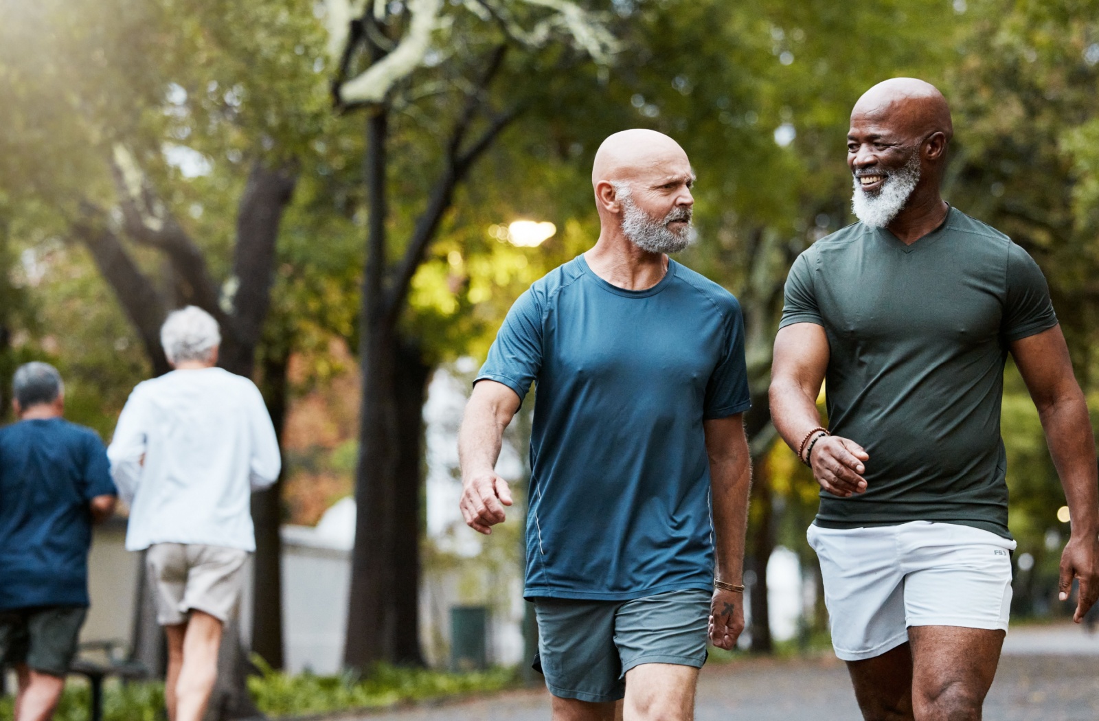 Seniors talk with each other while on a low impact walk through a neighborhood.